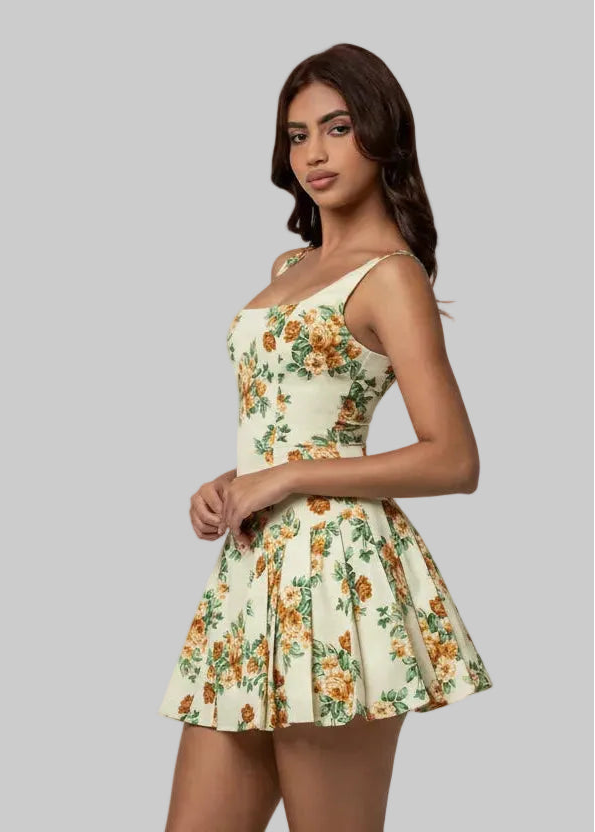 Woman wearing a floral dress against a plain background