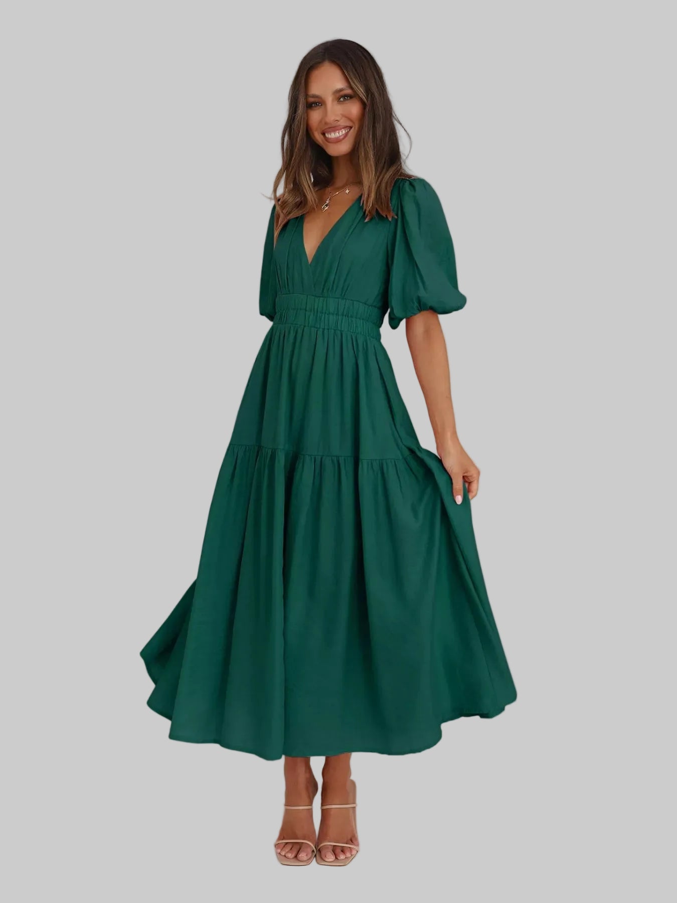 Woman wearing a green dress in a minimal white room