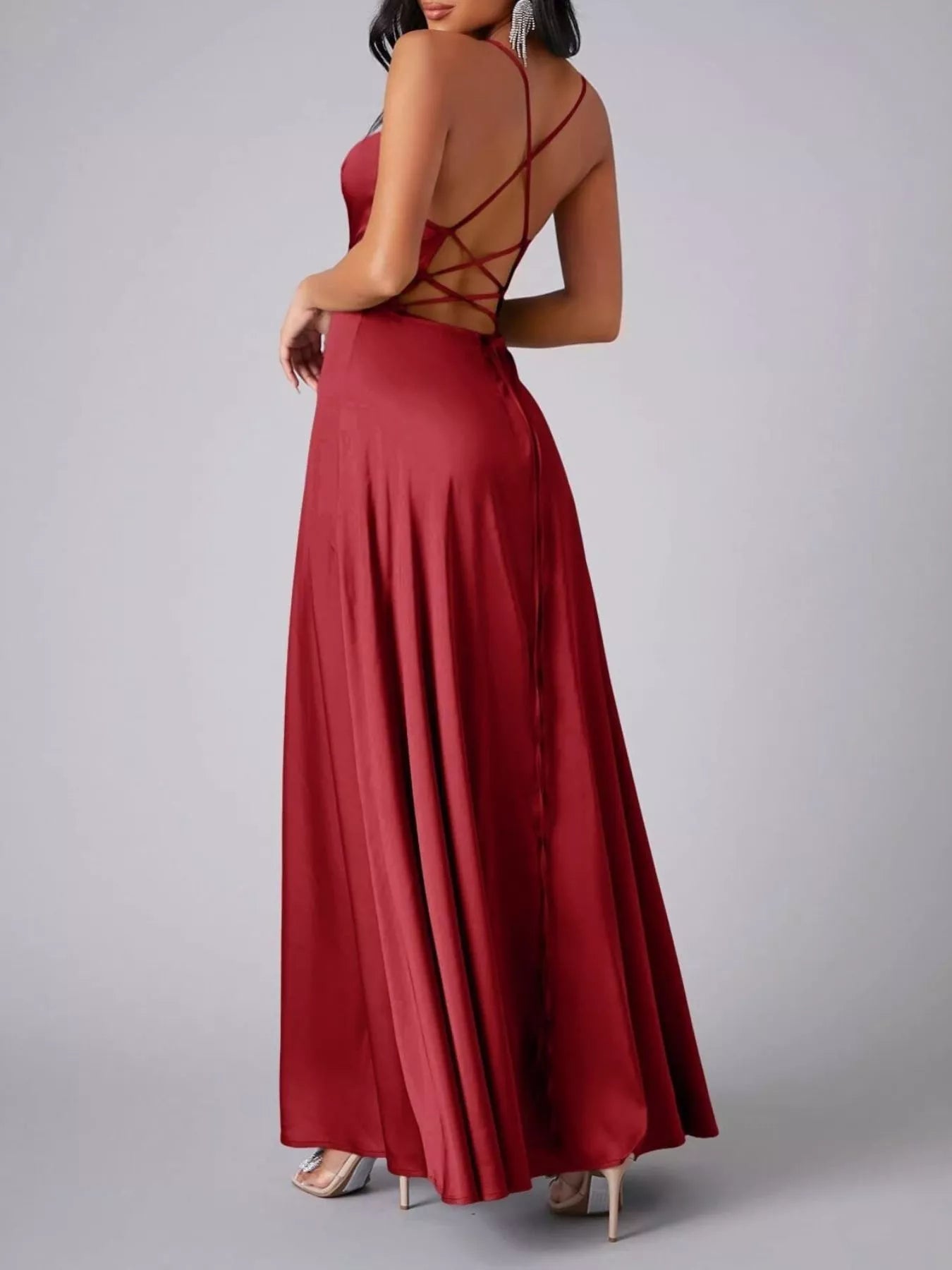 Red evening gown with criss-cross back design on a gray background