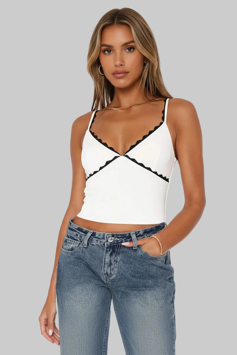 White tank top with black lace details worn by a person, with a white background